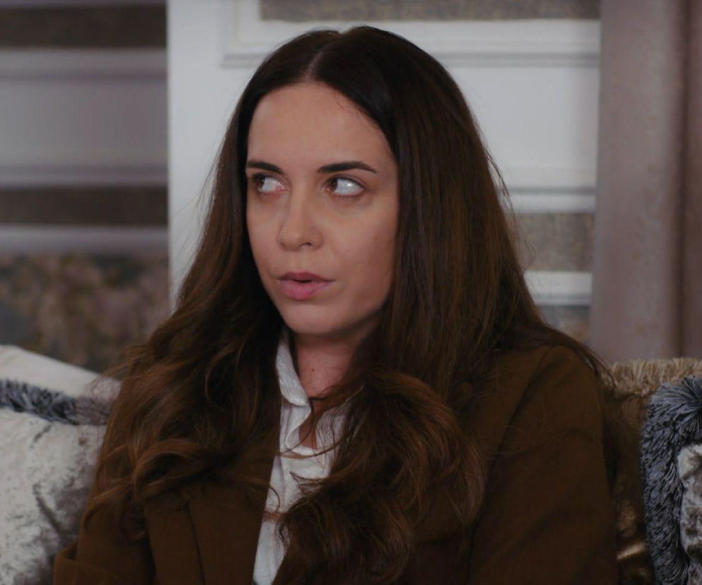 Kobieta o długich brązowych włosach patrzy z niepokojem w bok. O losach bohaterów serialu Panna młoda przeczytasz w Eska.