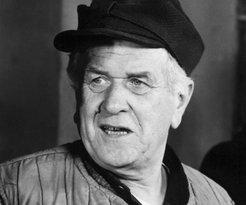 Aktor Wacław Kowalski jako Kazimierz Pawlak w czapce i kamizelce. Rozwiąż quiz o serii Sami Swoi na EskaRock.