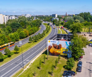 Otoczony reklamami dom przy Dolinie Służewieckiej w Warszawie