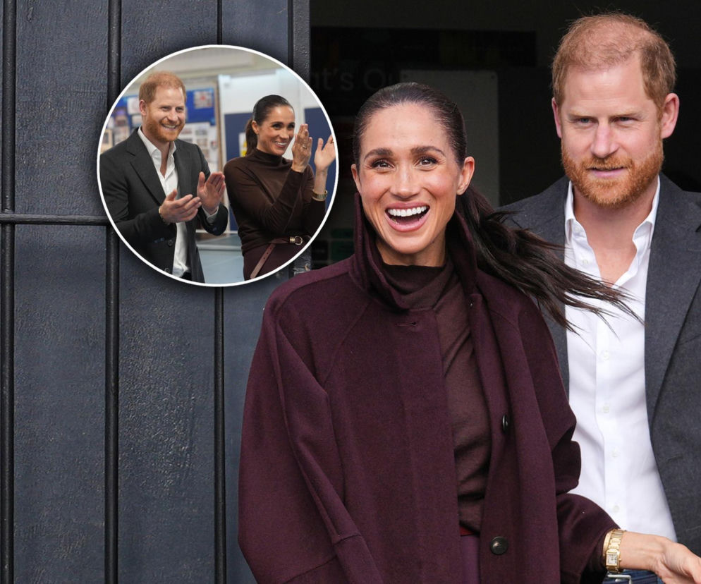 Uśmiechnięta Meghan Markle i książę Harry. Na miniaturze para klaszcze. O braku pierścionka Meghan przeczytasz na SE.
