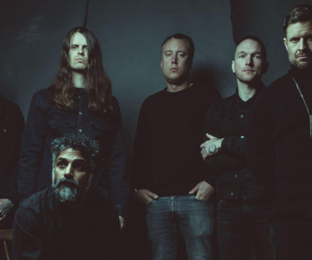 Sześciu członków zespołu post-metalowego Cult of Luna na ciemnym tle. O koncercie w Polsce przeczytasz na EskaRock.