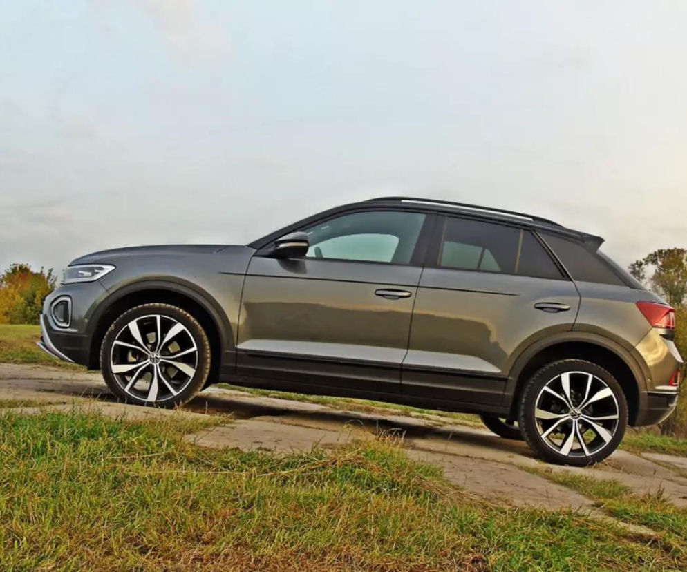 Srebrny Volkswagen T-Roc zaparkowany bokiem na wzniesieniu. O leasingu tego modelu przeczytasz na Eska.