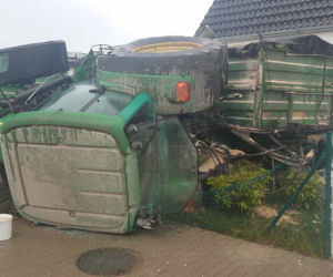 Groźna kolizja w Dąbczu. Traktor z przyczepami wjechał w dom i przewrócił się
