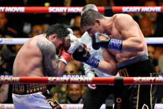 Ukraine's Oleksandr Usyk throws a flurry of punches at Netherlands' Rico Verhoeven