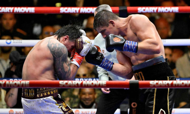 Ukraine's Oleksandr Usyk throws a flurry of punches at Netherlands' Rico Verhoeven