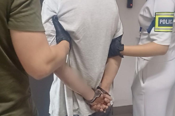 Zatrzymany przez policję 25-latek z rękami w kajdankach. O oszustwie na seniorze przeczytasz w Eska Nowy-Sącz.