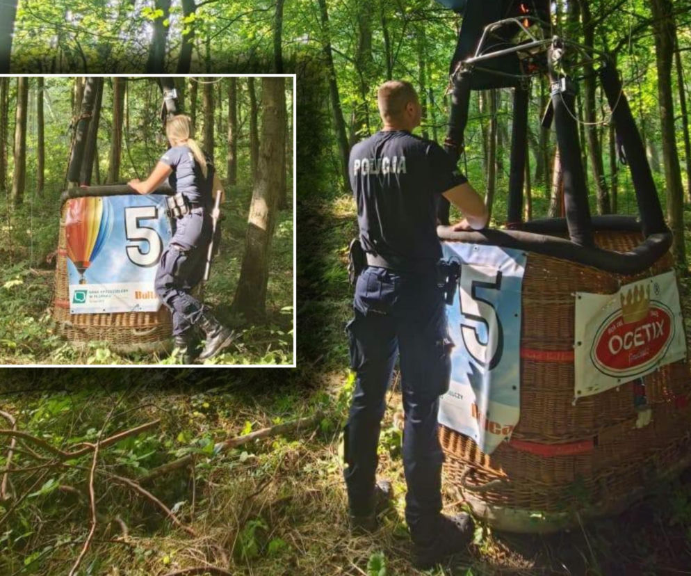 Policjant przy koszu balonu w lesie. Na miniaturze obok policjantka. O wypadku balonu przeczytasz na SE.