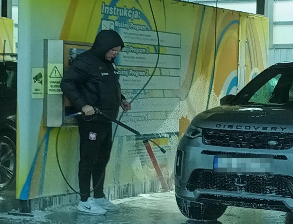 Czesław Michniewicz myje auto w stroju selekcjonera