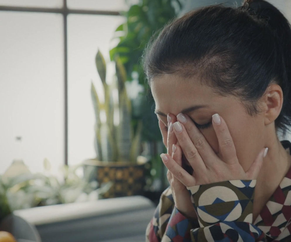 Kinga Zduńska (Katarzyna Cichopek) z serialu M jak miłość zakrywa twarz dłońmi, wyrażając stres i niepokój, związany z przesłuchaniem jako wiceprezeska fundacji. Taki fragment i więcej emocjonujących scen znajdziesz na Super Seriale.