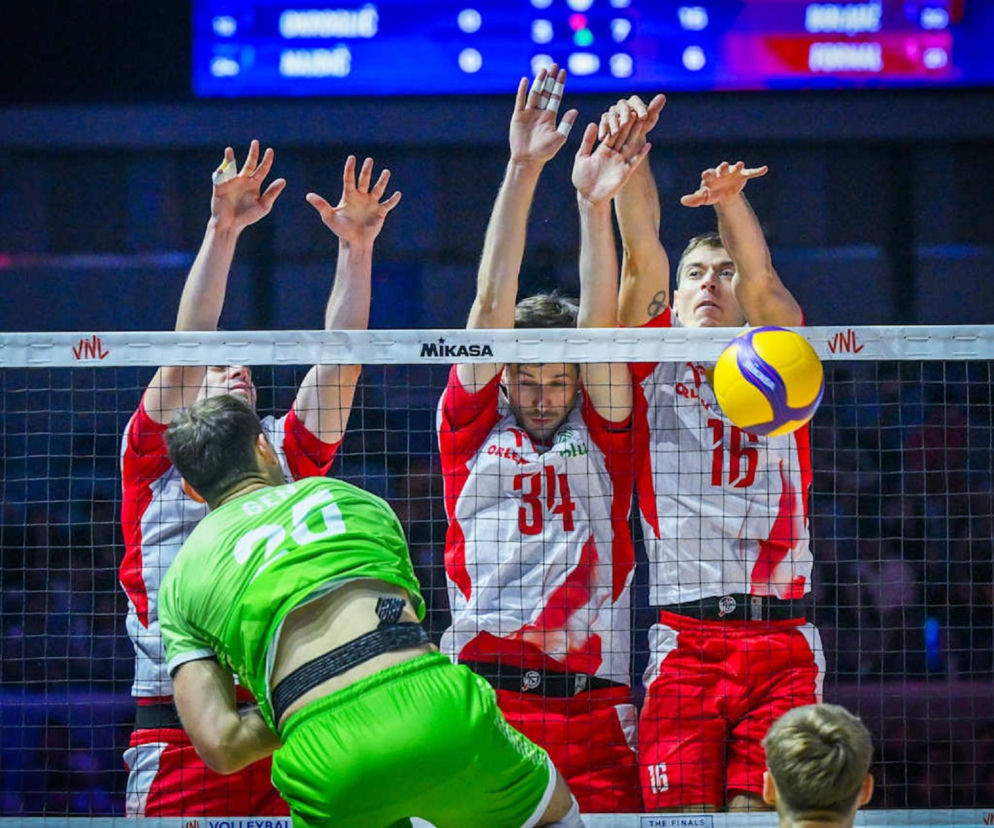 Trzej polscy siatkarze w biało-czerwonych strojach skaczą do bloku przy siatce. O nagrodach w VNL czytaj na SE Supersport.
