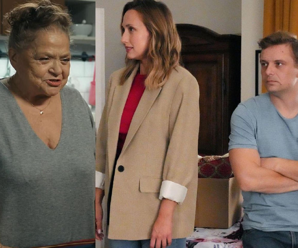 Lucyna (Grażyna Zielińska) z serialu Barwy szczęścia w szarej bluzce z dekoltem, rozmawia z Joasią (Anna Gzyra) w beżowej marynarce i czerwonej bluzce oraz Hubertem (Marek Molak) w niebieskiej koszulce z rękami skrzyżowanymi na klatce piersiowej. Wszyscy wydają się zamyśleni. Więcej informacji o serialu znajdziesz na Super Seriale.