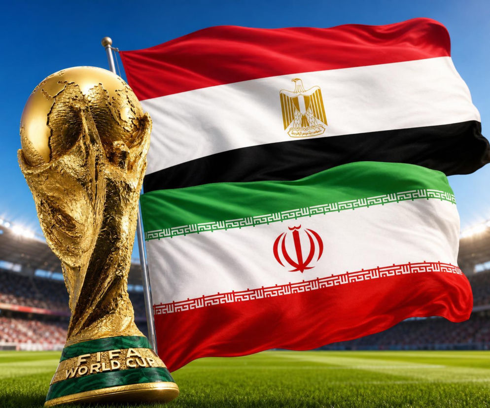 Złote trofeum FIFA World Cup na zielonej murawie stadionu, z powiewającymi flagami Egiptu (czerwono-biało-czarna z orłem) i Iranu (zielono-biało-czerwona z godłem) w tle. Scena symbolizuje nadchodzące starcie tych drużyn w ramach Mundialu, o którym można przeczytać na naszym portalu.